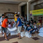 With the help of the villagers, rice was repacked into smaller bags.