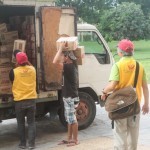 Local people helping our Association members unload relief