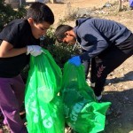 All ages help with the clean-up at Camp Moria in Lesbos, Greece. November 2015