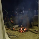 Refugees in Idomeni, Greece, trying to keep warm on a cold night - December 7, 2015