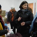 Local Greek people giving food, warm clothes and shoes to the refugees in Kavalas, Greece - December 9, 2015