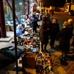 Local Greek people giving food, warm clothes and shoes to the refugees in Kavalas, Greece - December 9, 2015
