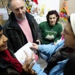 Local Greek people reading our flyer in Kavalas, Greece - December 9, 2015