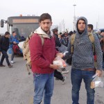 20151215 around 8AM refugees are blissful happy to receive our foods and flyer at Pireaus harbor in Athens Greece (32)
