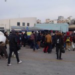 20151215 around 8AM refugees are blissful happy to receive our foods and flyer at Pireaus harbor in Athens Greece (8)