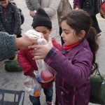 20151215 around 8AM refugees are blissful happy to receive our foods and flyer at Pireaus harbor in Athens Greece (96)