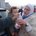 20151215 around 8AM refugees are blissful happy to receive our foods and flyer at Pireaus harbor in Athens Greece (97)