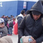 20151217 around 10AM refugees are blissful happy to receive our foods and flyers at Pireaus harbor in Athens Greece (106)-b