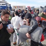 20151217 around 10AM refugees are blissful happy to receive our foods and flyers at Pireaus harbor in Athens Greece (19)
