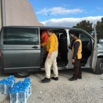 the team loading the van with water bottles at Taekwondo stadium to take to Elliniko