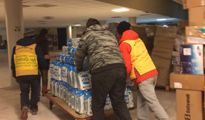 unloading water bottle at Elliniko camp