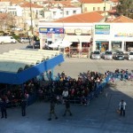 Refugees lining up at Chios port to board ferryboat to Athens