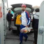 Algerian Refugee Helping to Put Vegan Food Packs in a Storage