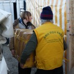 Unloading relief items at BetterDaysforMoria OliveGrove camp-with help from volunteers