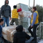 Unloading relief items at BetterDaysforMoria OliveGrove camp-with help from volunteers and refugees2