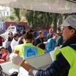 Volunteers distributing vegan lunch at Souda refugee Camp
