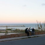 Two refugees eating vegan food outdoor by the sea