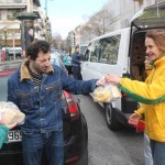 Distributing vegan food packs at Victoria park, Athens, Greece