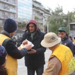 Distributing vegan food packs at Victoria park, Athens, Greece