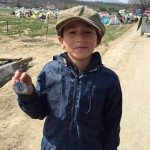 Child holding Master's badge, Idomeni, Greece
