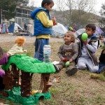 Children doing a puppet show performance at the BP service station camp