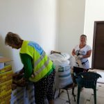 Volunteers from "A Drop in the Ocean" helping pack the peanuts and raisins, Chios Island, Greece