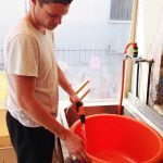 Lukas - volunteer washing a tub, Chios Island, Greece
