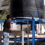160591_Syrian Refugees in Gaza drinking water from farmers rebuilt well.3